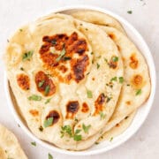 close up shot of sourdough naan with garlic cilantro butter