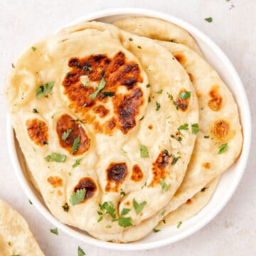 close up shot of sourdough naan with garlic cilantro butter