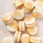 close up of champagne macarons with gold paint