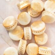 close up of champagne macarons with gold paint