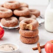 close up of stack of apple cider baked donuts