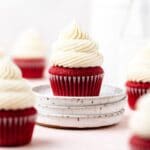 close up of red velvet cupcakes with cream cheese frosting.