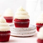 close up of red velvet cupcakes with cream cheese frosting.