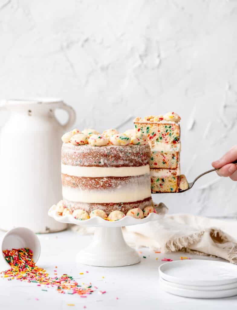 funfetti birthday cake with slice missing. milk bar copycat
