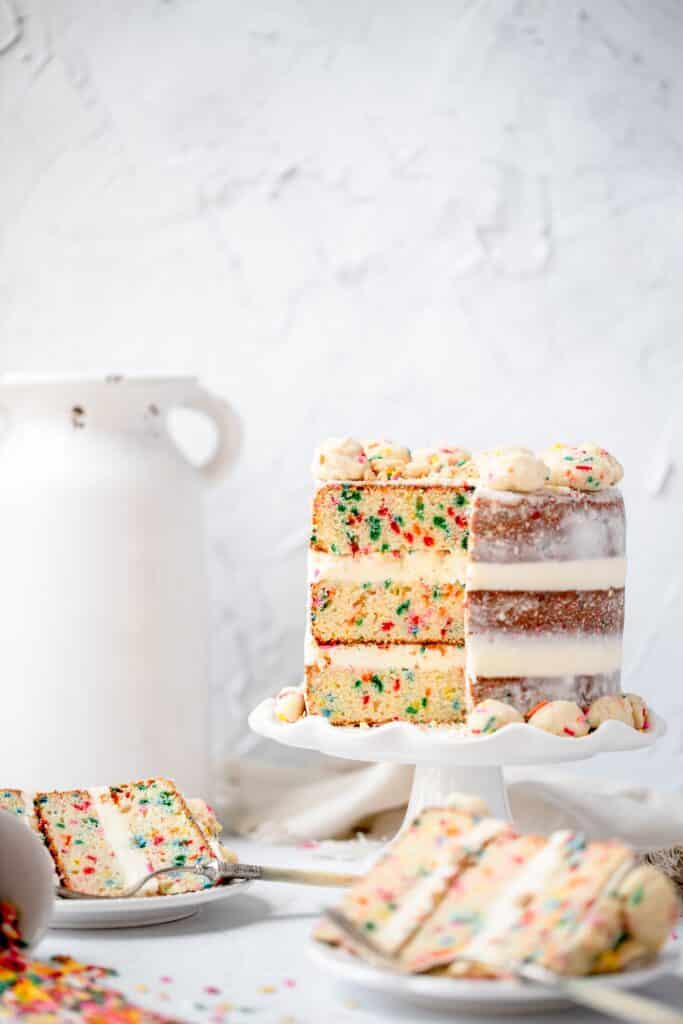 funfetti birthday cake with slice missing. milk bar copycat cake