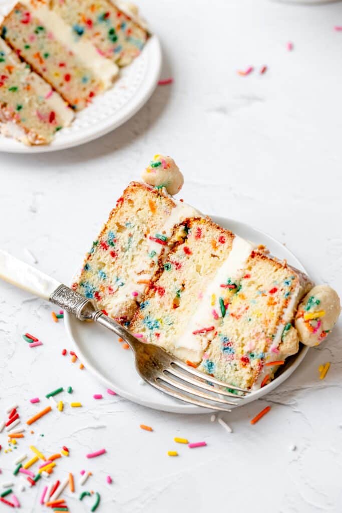 slice of funfetti layer cake. milk bar copycat