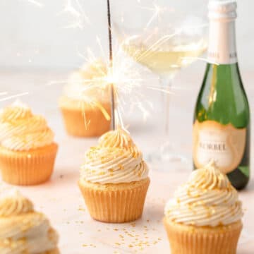 close up of champagne cupcakes with sparkler on top