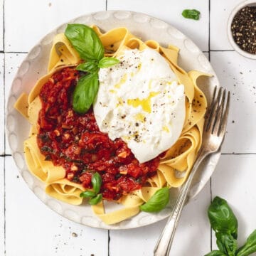 homemade pomodoro sauce on top of pasta with burrata