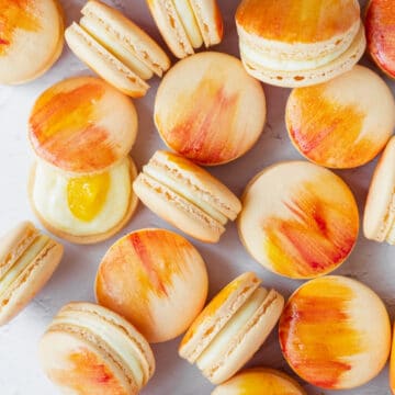 up close shot of watercolor mango macarons