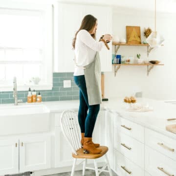 kyleigh standing on chair taking food photos