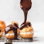 close up shot of chocolate covered cream puffs