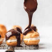 close up shot of chocolate covered cream puffs