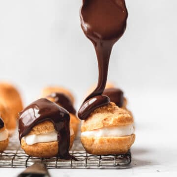 close up shot of chocolate covered cream puffs