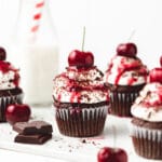 close up photo of black forest cupcakes with fresh cherries