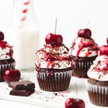 close up photo of black forest cupcakes with fresh cherries