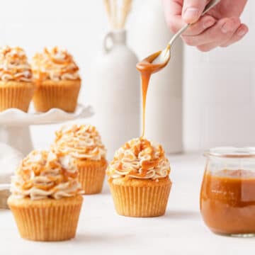 close up of brown butter salted caramel cupcakes with caramel drizzle