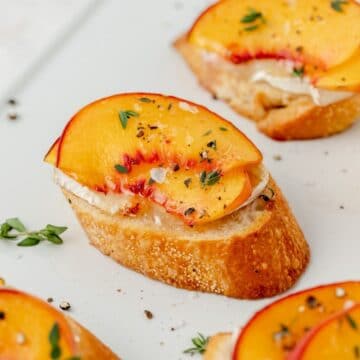 close up of peach and brie crostini