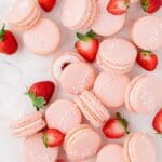 close up of strawberry macarons with fresh strawberries