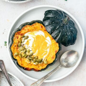 close up of roasted acorn squash soup in acorn squash bowl