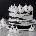 close up of black cocoa halloween cake with spider webs and ghosts