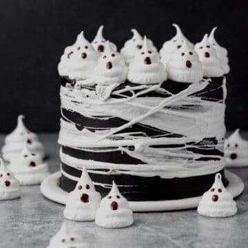 close up of black cocoa halloween cake with spider webs and ghosts