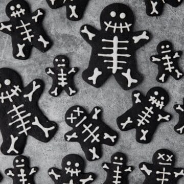 close up of black cocoa skeleton shortbread cookies