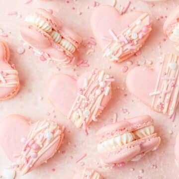 close up of heart shaped macarons with white chocolate ganache.