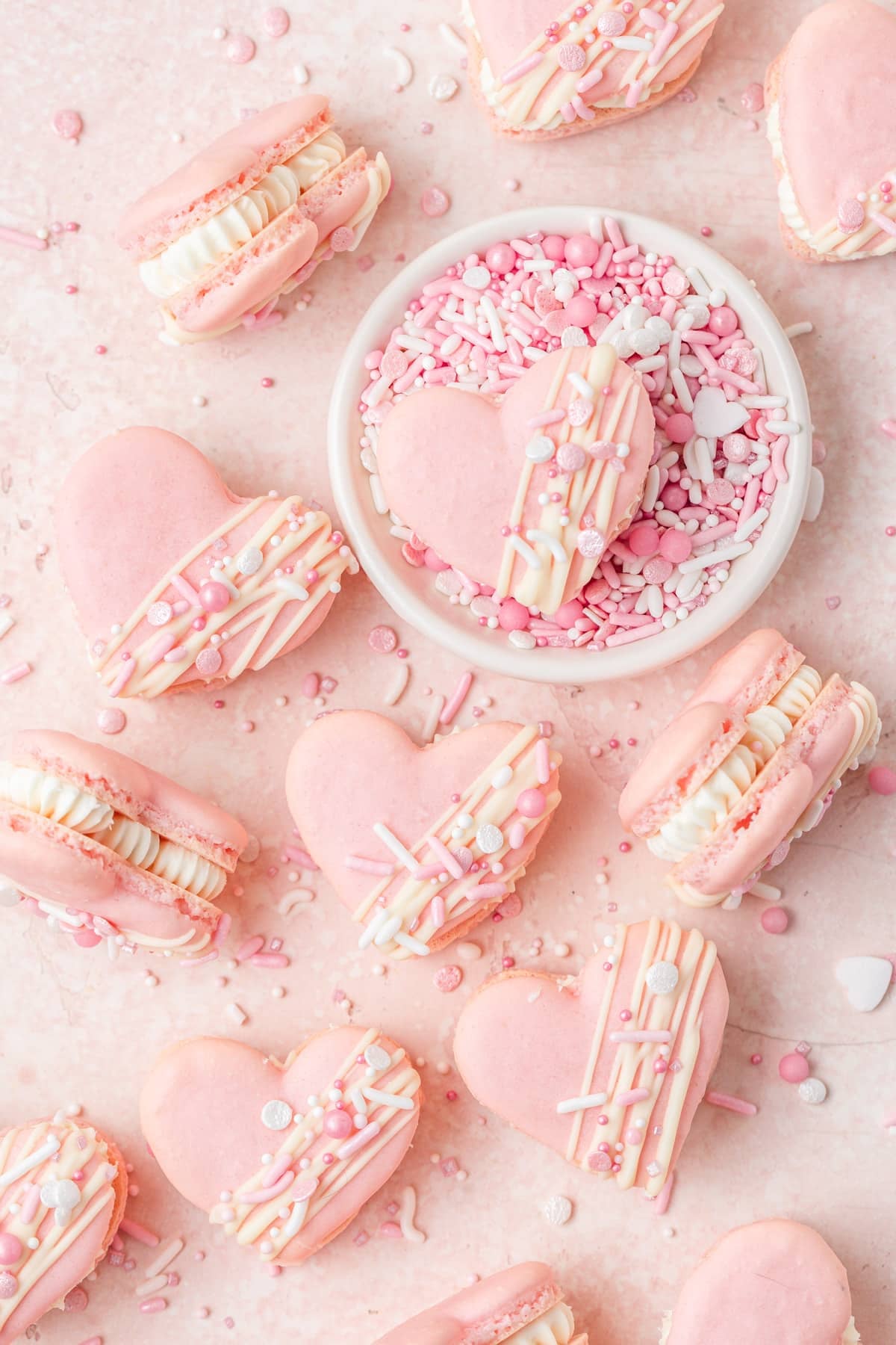 pink heart shaped macarons filled with white chocolate ganache.