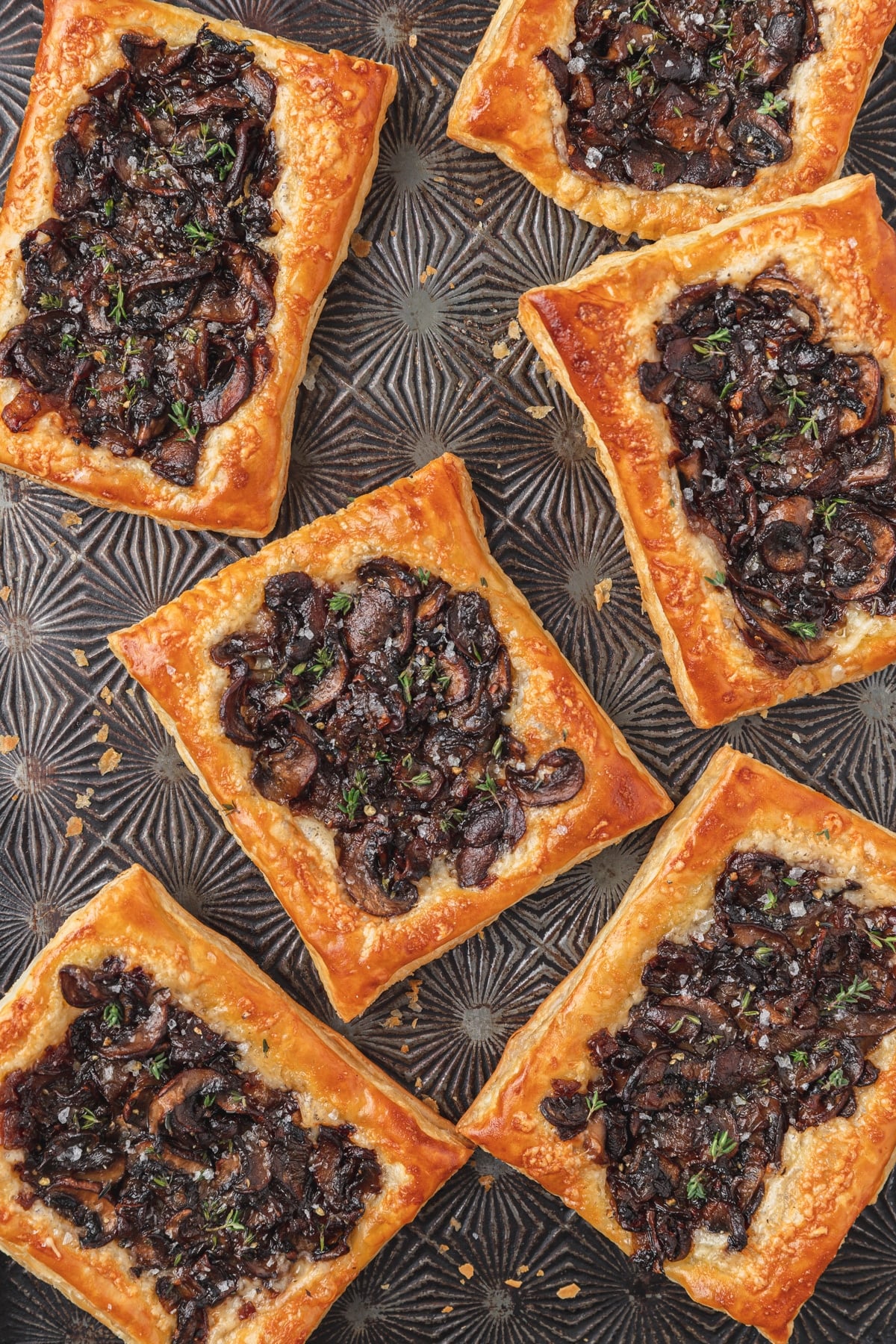 mushroom puff pastry tarts on baking sheet