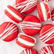close up of red velvet macarons with cream cheese frosting