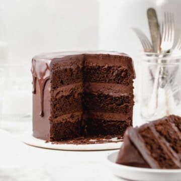 super close up of triple chocolate layer cake with chocolate drip.