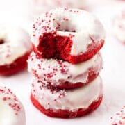 close up of red velvet baked donuts with cream cheese frosting.