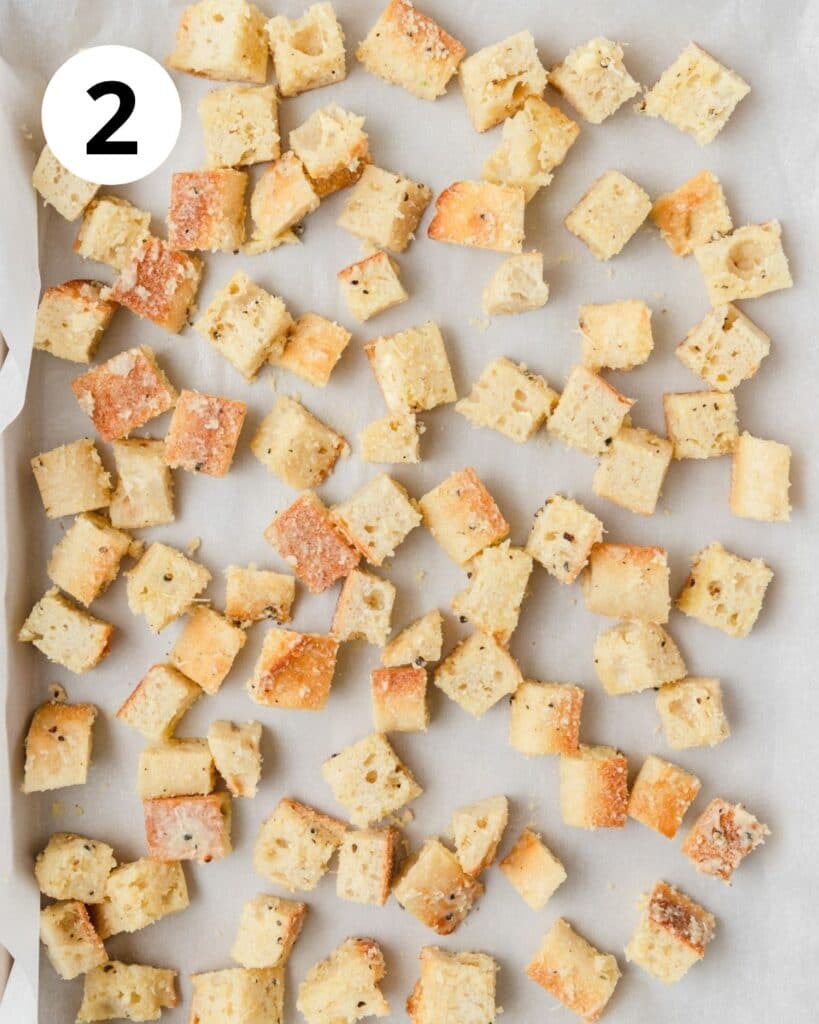 spreading croutons on baking sheet before baking.