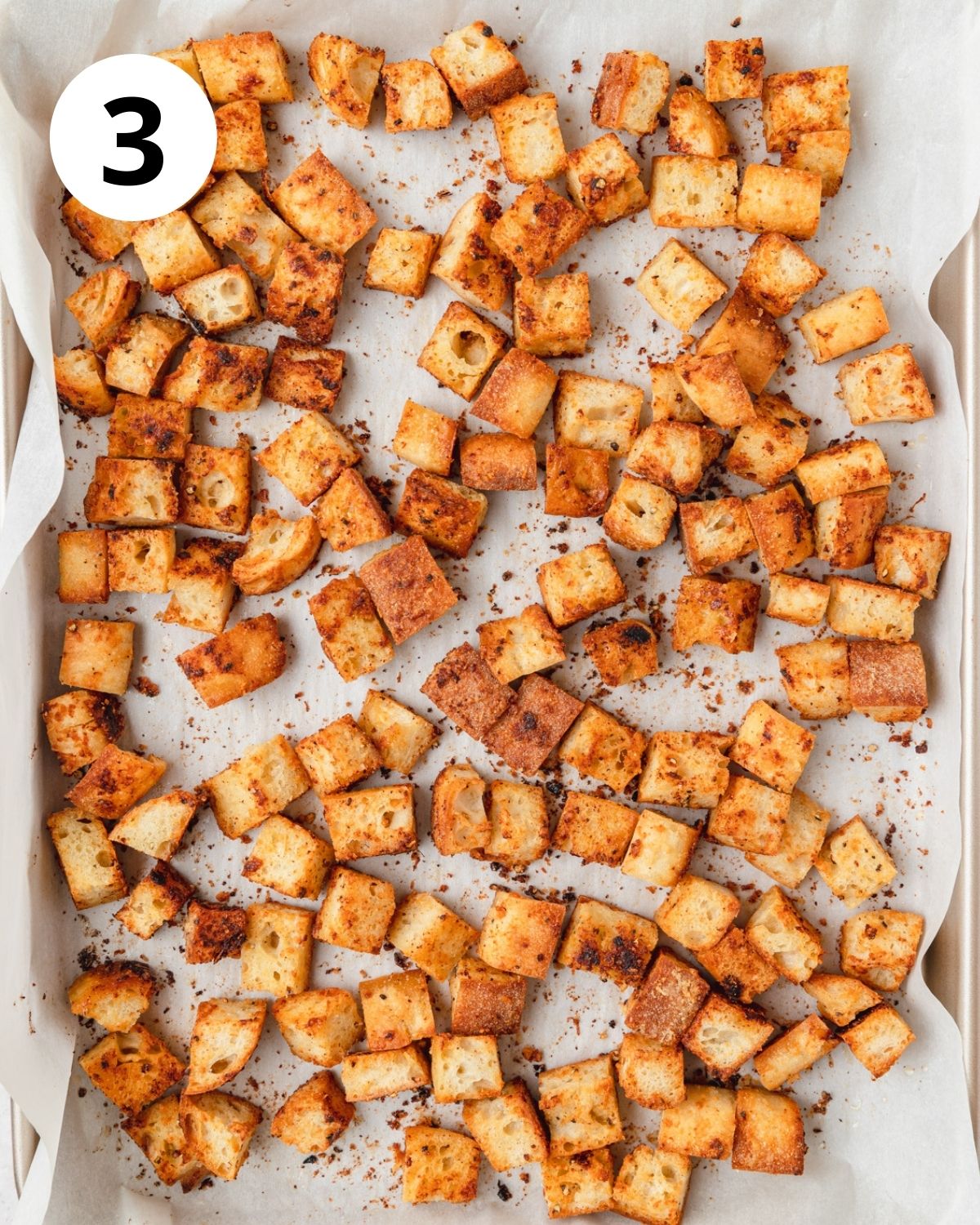 crispy homemade croutons on baking sheet after baking.