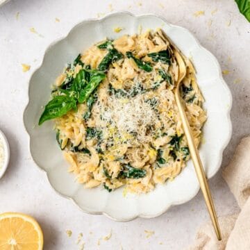 close up of creamy lemon spinach orzo.