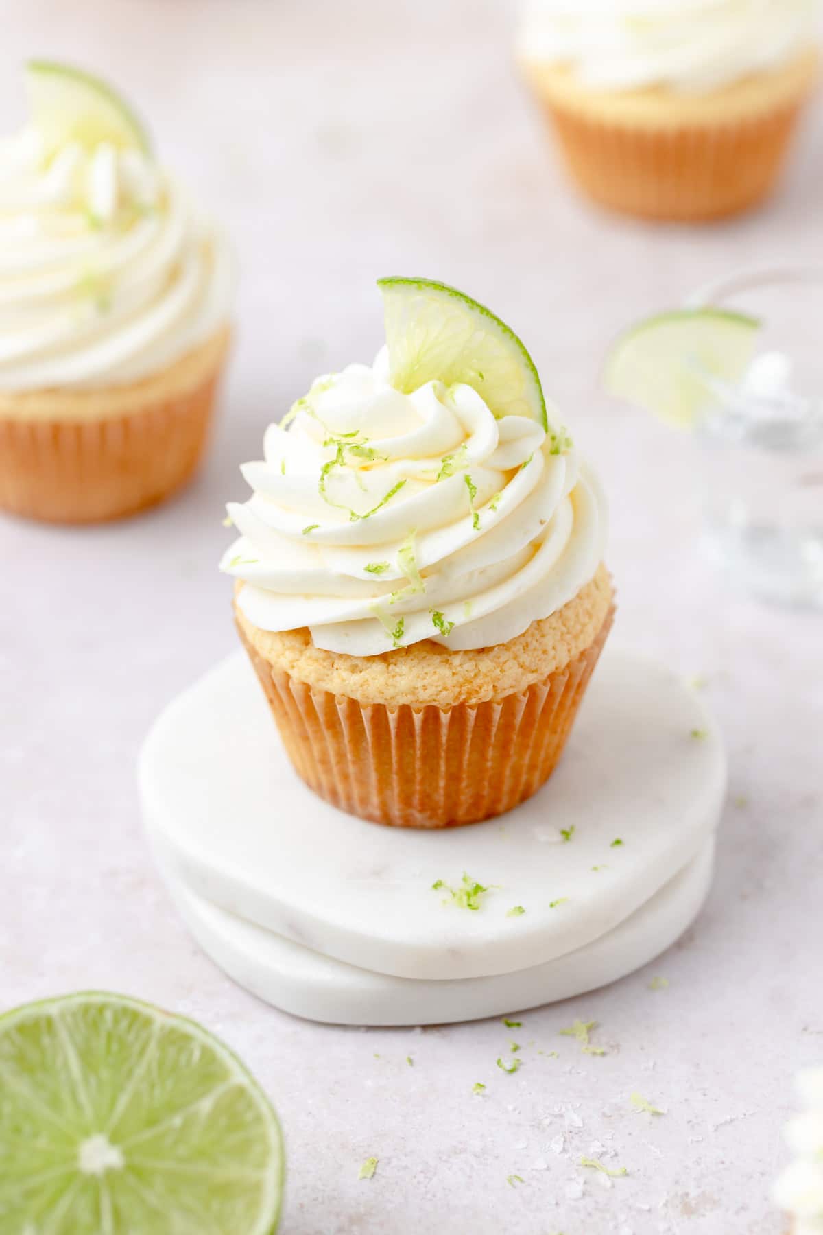 margarita cupcakes with lime slices on top.