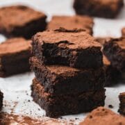 close up of red wine brownies with cocoa powder on top.