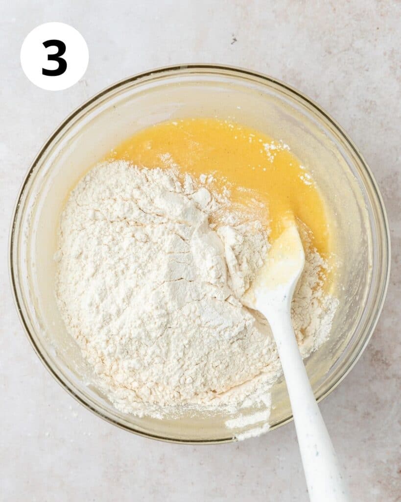 adding dry ingredients to vanilla cake batter.