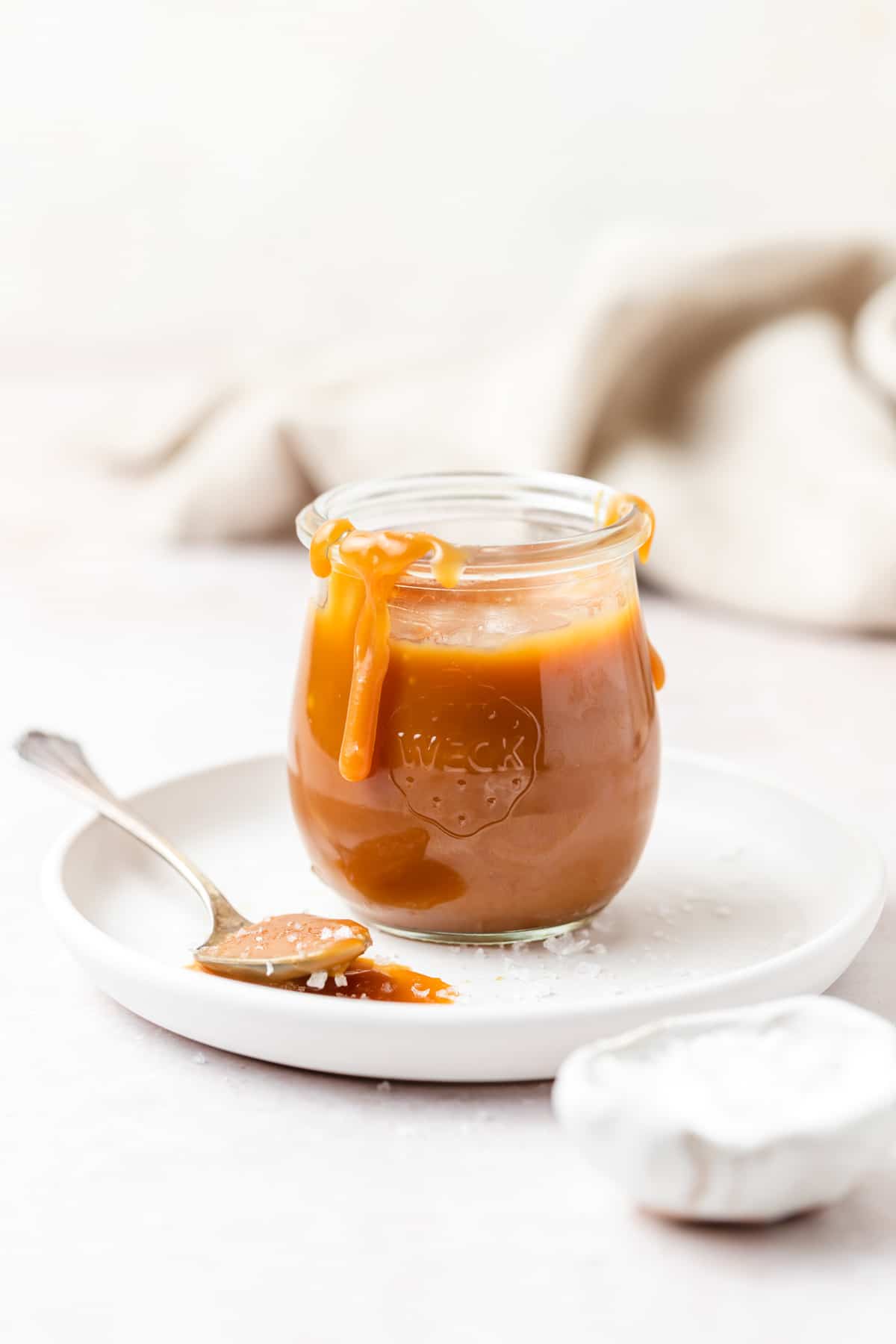 glass jar of homemade salted caramel sauce.