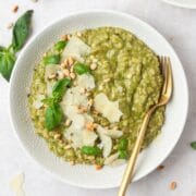 close up of pesto risotto with toasted pine nuts.