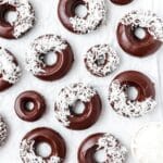 close up of baked chocolate coconut donuts.