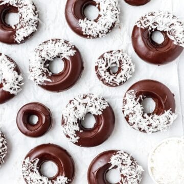 close up of baked chocolate coconut donuts.