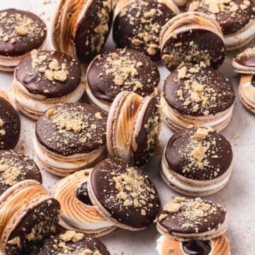 close up of s'mores macarons with toasted meringue.