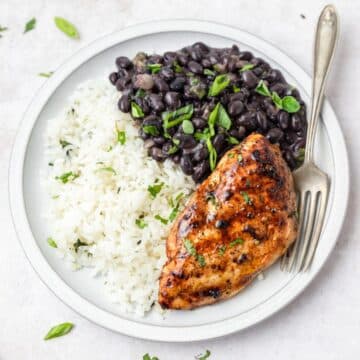 close up of beans and rice with mojo chicken.