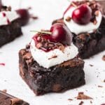 close up of black forest brownies topped with cherries.