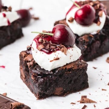 close up of black forest brownies topped with cherries.