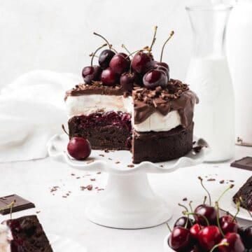 close up of black forest ice cream cake topped with cherries.