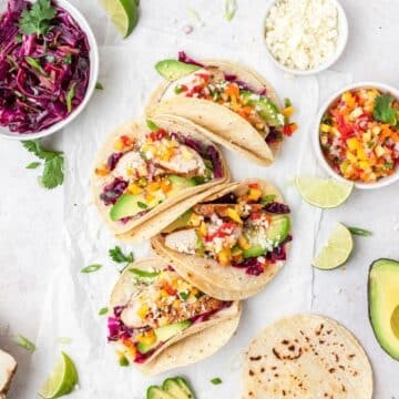 close up of grilled chicken tacos with peach mango salsa.