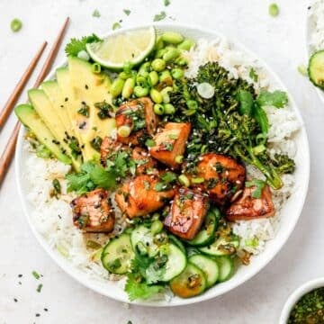 close up of salmon rice bowls with crispy broccoli and avocado.