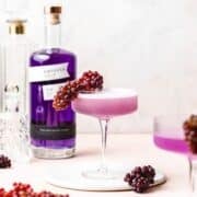 close up of empress gin french 75 with champagne grapes.